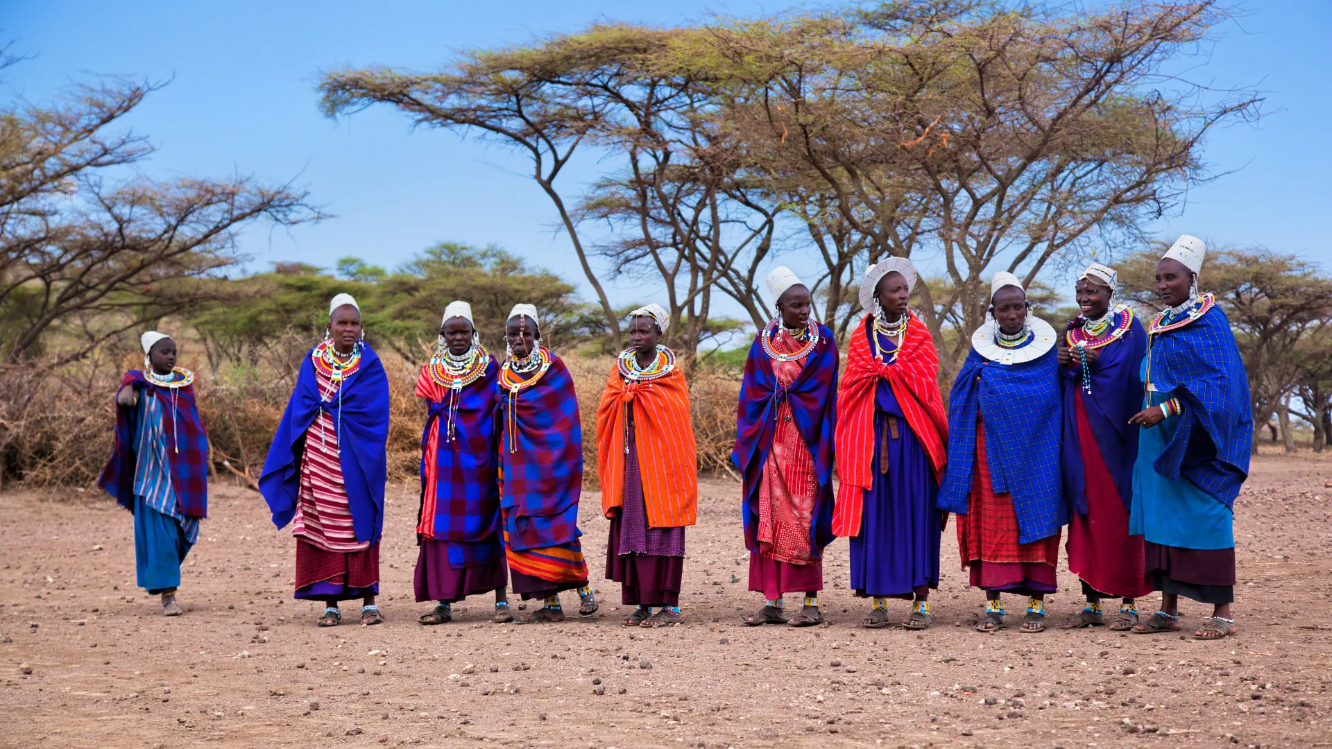 Maasai community members beneath acacia trees in northern Tanzania