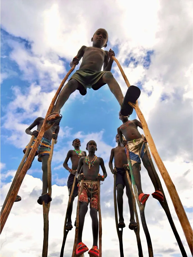 Makonde stilt dancers performing against an open sky
