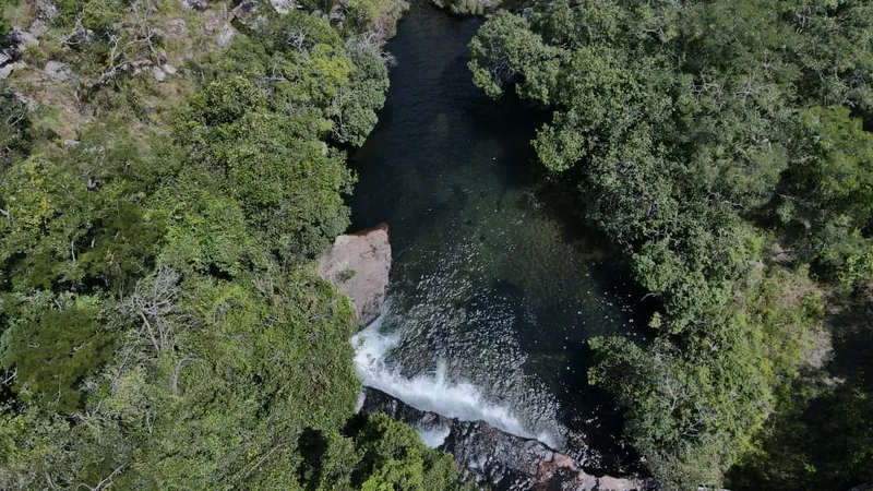 Aerial view of a forest pool and small cascade at Mpanga-Kipengere